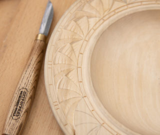 геометрический резной узор на деревянной тарелке